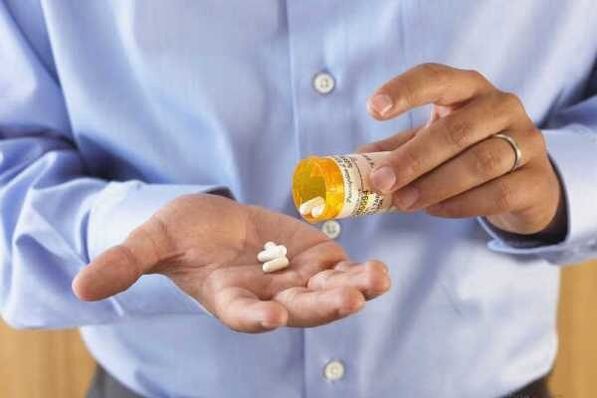 A man takes medication to treat prostatitis